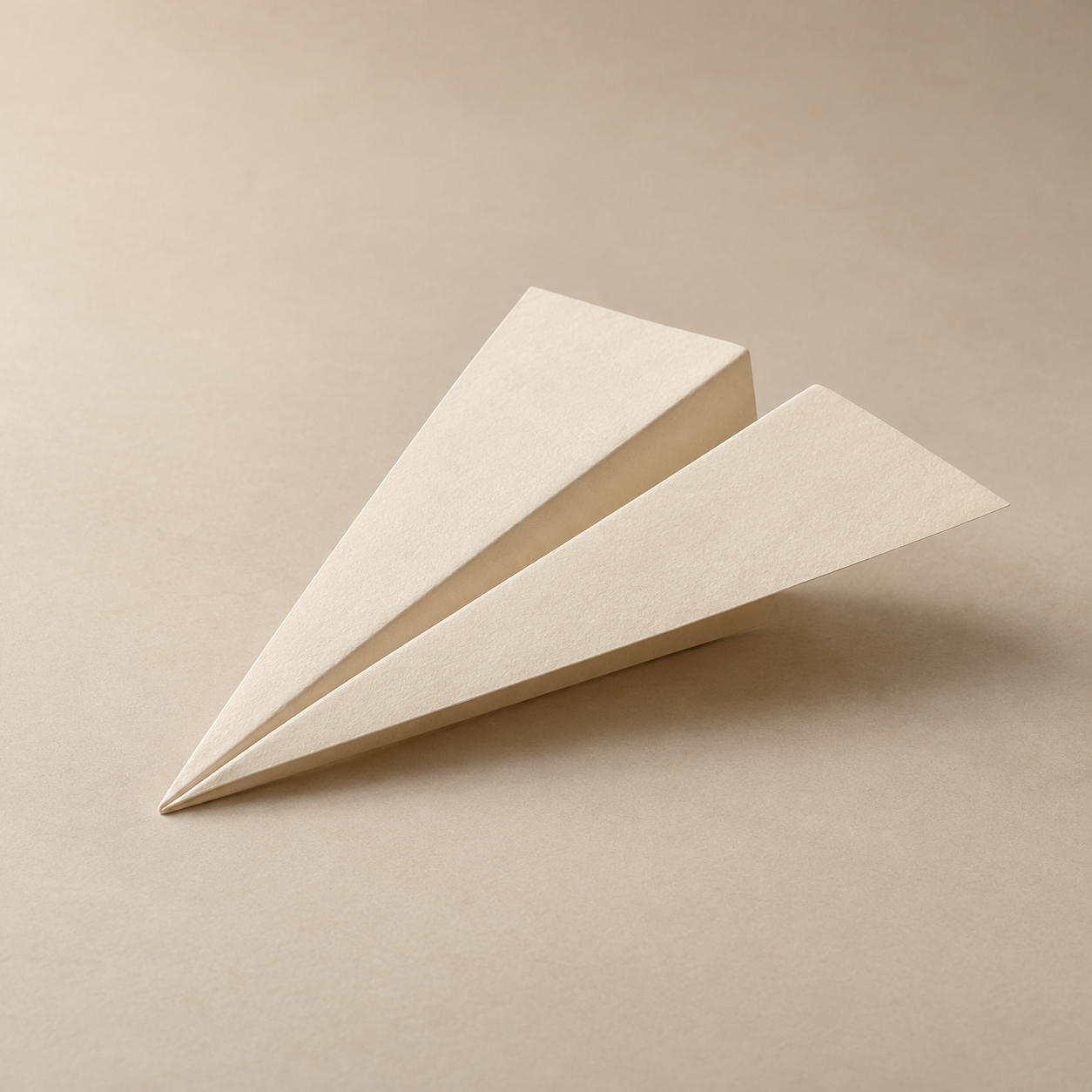 A folded ivory paper airplane